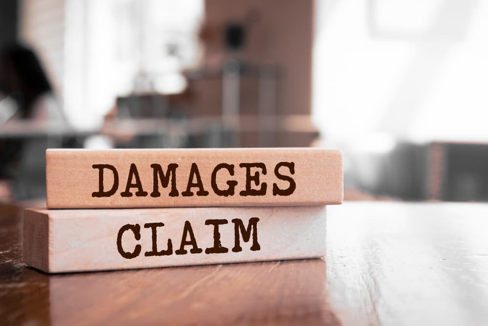 Wooden blocks with words 'Damages Claim'..